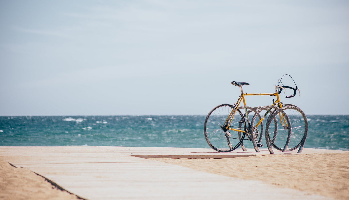 A used vintage bike on a boardwalk over looking the ocean.